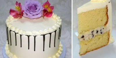 A white frosted cake decorated with purple and pink flowers, shown next to a slice of the cake revealing its layers.
