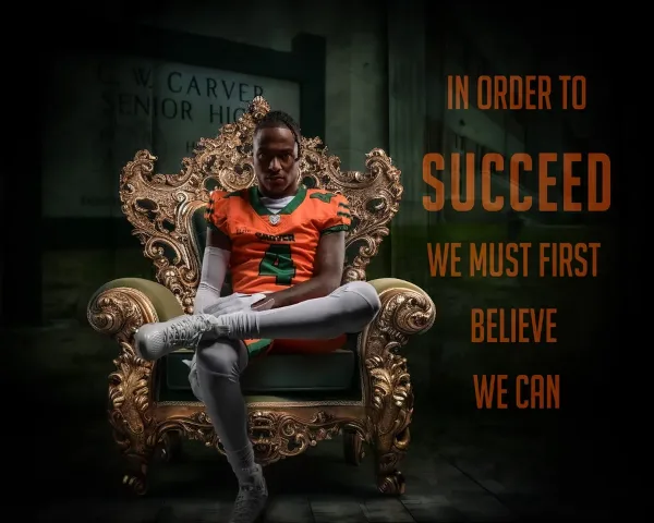 A high school football player in an orange jersey sitting on an ornate gold chair in a studio setting.