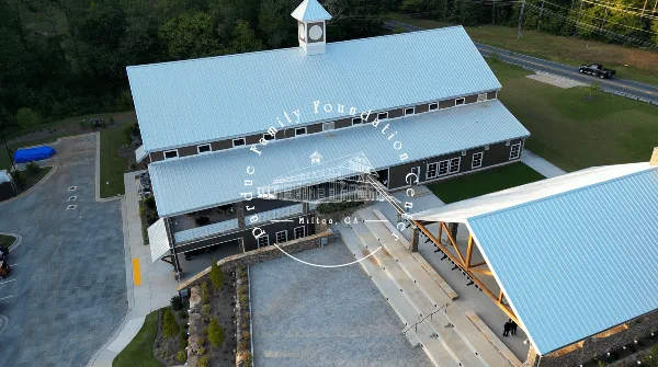 Aerial view of the Pardue Family Foundation Center event venue in Milton, GA, showing the main building, outdoor seating area, and surrounding grounds.