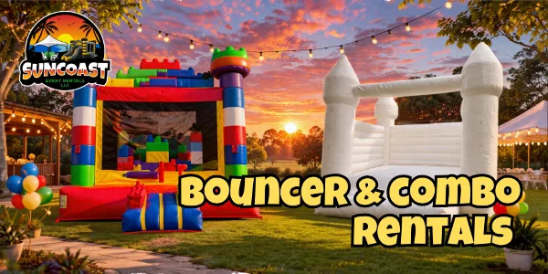 Outdoor event setup featuring colorful inflatable bounce houses and a white castle-style bouncer under string lights at sunset.