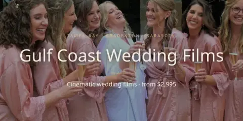 A bride and her bridesmaids in pink robes laughing and holding champagne flutes.