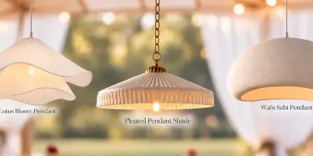 Three decorative pendant lights hanging inside a white tent with string lights in the background.