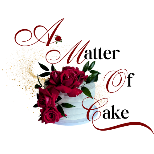 A white tiered cake decorated with red roses and gold accents.