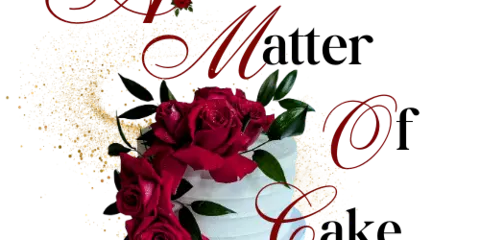 A white tiered cake decorated with red roses and gold accents.