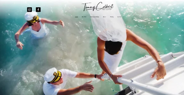 A creative wedding photograph showing a bride in a white dress and veil climbing a ladder into turquoise water, assisted by two men in white sailor uniforms.