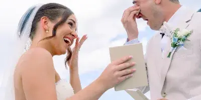 A bride and groom sharing a joyful, emotional moment during their outdoor wedding ceremony.