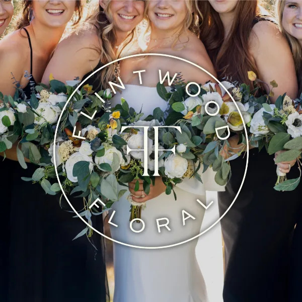 A bride and bridesmaids holding white and green floral bouquets with the Flintwood Floral logo overlaid.