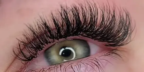 Close-up of an eye with long, full eyelashes