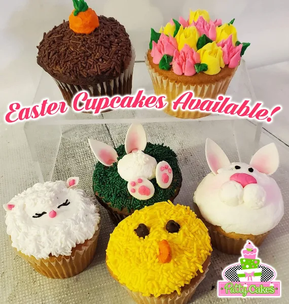 A collection of decorated cupcakes featuring Easter-themed designs such as a bunny, a chick, and a lamb.