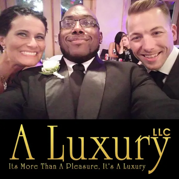 Three people in formal wedding attire smiling together at a reception, with the A Luxury LLC logo overlaid at the bottom.