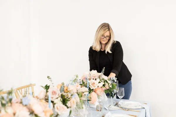 Whitney of WR Designs and Decor setting floral tablescape
