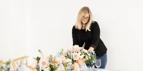 Whitney of WR Designs and Decor setting floral tablescape