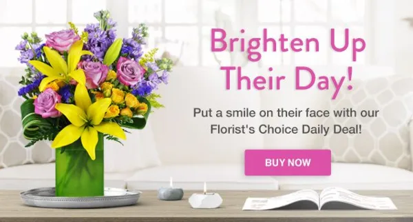 A colorful bouquet of flowers in a green vase sitting on a table in a living room setting.