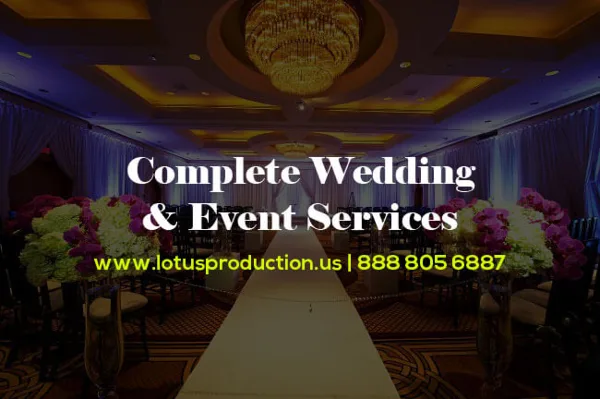A decorated wedding venue featuring a long table, floral centerpieces, and a chandelier.