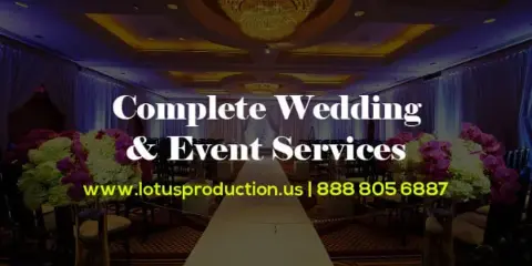 A decorated wedding venue featuring a long table, floral centerpieces, and a chandelier.