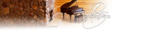 Interior view of an event venue featuring a stone fireplace and a grand piano.