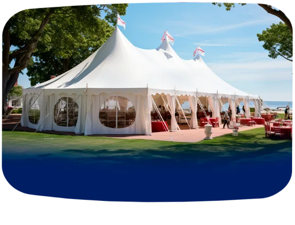A large white event tent set up outdoors with tables and chairs for a wedding or special event.