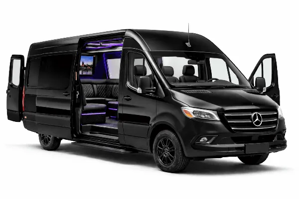 Black Mercedes Sprinter van with open side door revealing a luxury interior with purple mood lighting and leather seating.