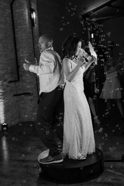 A bride and groom dancing on a dance floor at a wedding event venue.