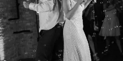 A bride and groom dancing on a dance floor at a wedding event venue.