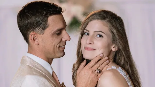 A bride and groom posing together at a wedding event.