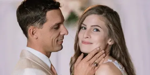 A bride and groom posing together at a wedding event.
