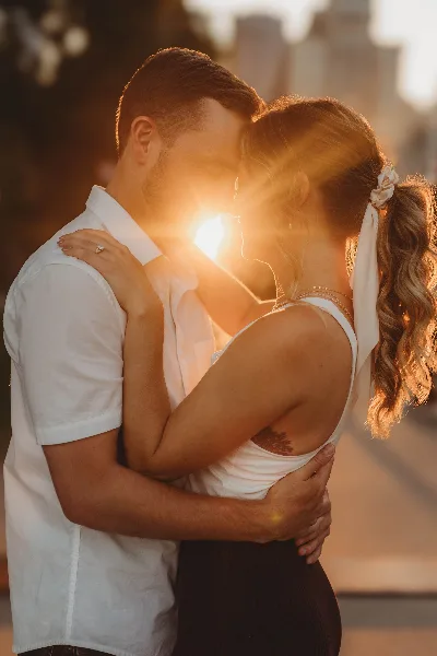 Couple embracing during a golden hour sunset photoshoot.