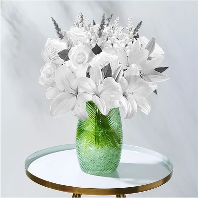 White rose and lily bouquet in a green vase on a small table