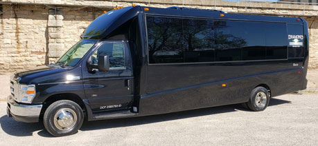 A black luxury shuttle bus parked outdoors.