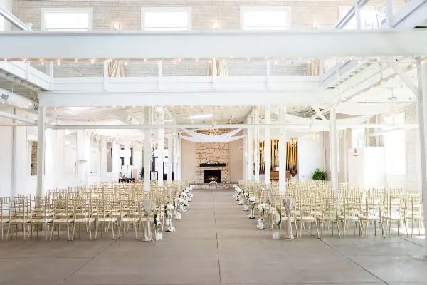 Interior view of the Grand Hall at Olde Wicks Factory, set up with rows of chairs for a wedding ceremony.