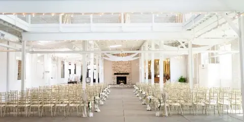 Interior view of the Grand Hall at Olde Wicks Factory, set up with rows of chairs for a wedding ceremony.
