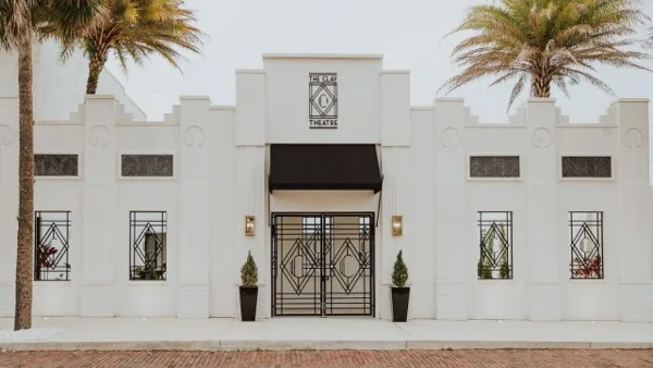 Exterior view of The Clay Theatre building featuring a white facade, Art Deco architectural details, and a central entrance.