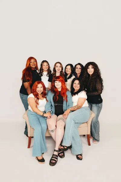 Group portrait of the Luna Jade Salon team members posing together.
