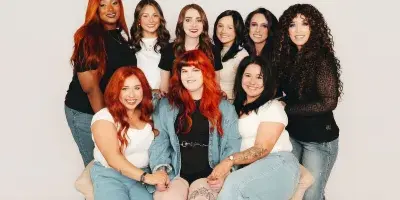 Group portrait of the Luna Jade Salon team members posing together.