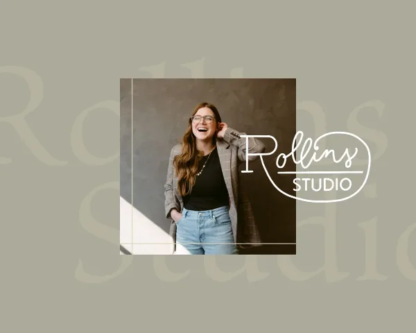 Portrait of a smiling woman with glasses and long hair, wearing a blazer and jeans, standing in a studio with a 'Rollins Studio' logo overlay.