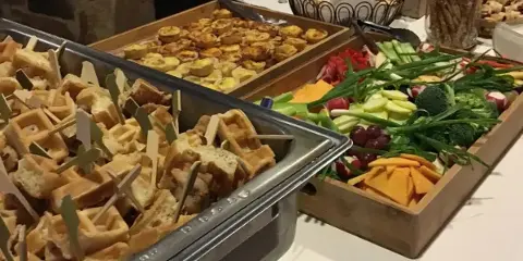 Wedding appetizer buffet with savory bites, fruit, and vegetables