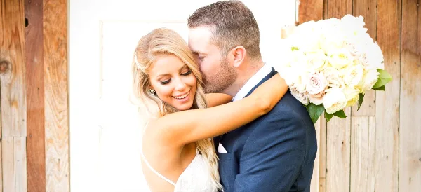 A bride and groom embracing in a wedding photograph.