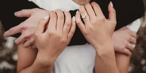 Close-up of a couple's hands showing wedding rings