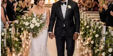 A bride and groom walking down the aisle during a wedding ceremony in a church.