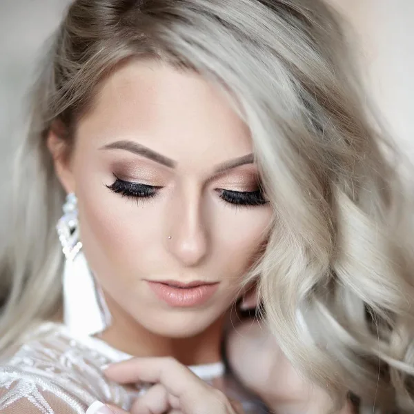 Close-up portrait of a woman with professional makeup and styled hair