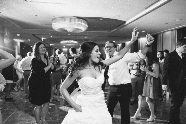 A bride dancing on a dance floor at a wedding reception.