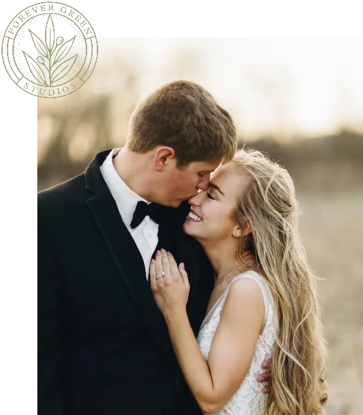 A professional wedding photograph of a couple embracing outdoors, featuring the Forever Green Studios logo in the top left corner.