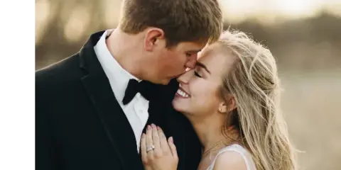 A professional wedding photograph of a couple embracing outdoors, featuring the Forever Green Studios logo in the top left corner.