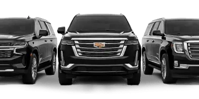 Three black luxury SUVs, including a Chevrolet, a Cadillac, and a GMC, parked side-by-side.
