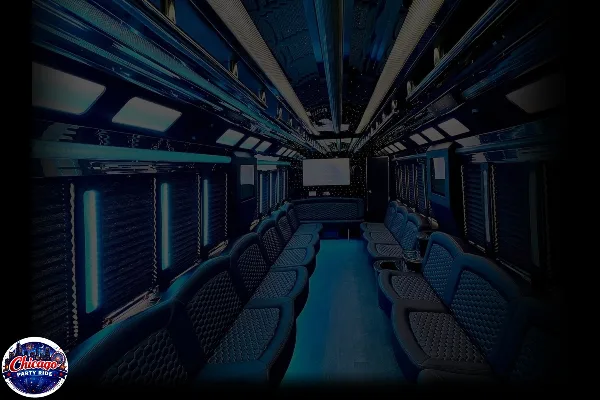 Interior view of a party bus featuring blue leather seating, ambient lighting, and a central aisle.