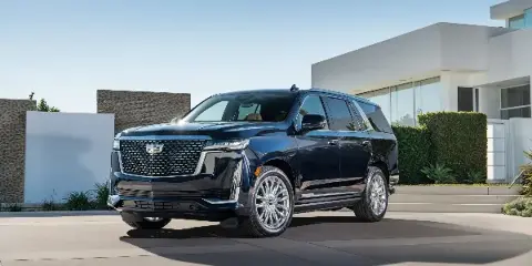 Black luxury SUV parked in front of a modern building