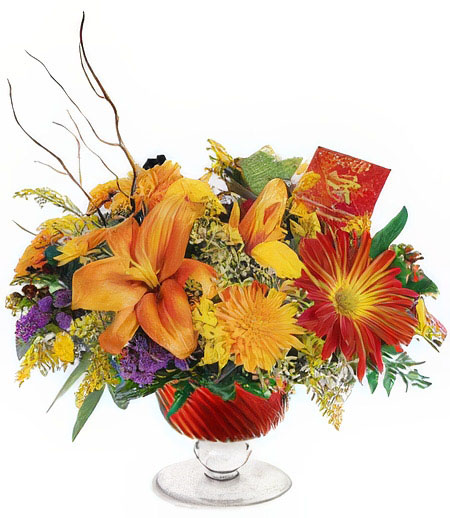 A floral arrangement featuring orange lilies, red daisies, and yellow chrysanthemums in a red glass vase.