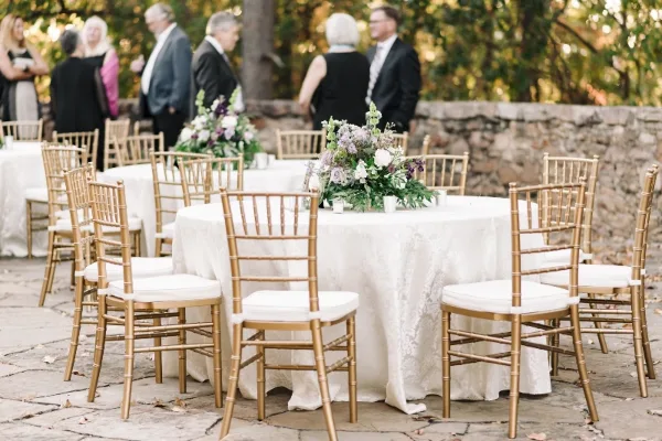 Gold chiavari chairs at an outdoor wedding reception by Alabama Event Rentals
