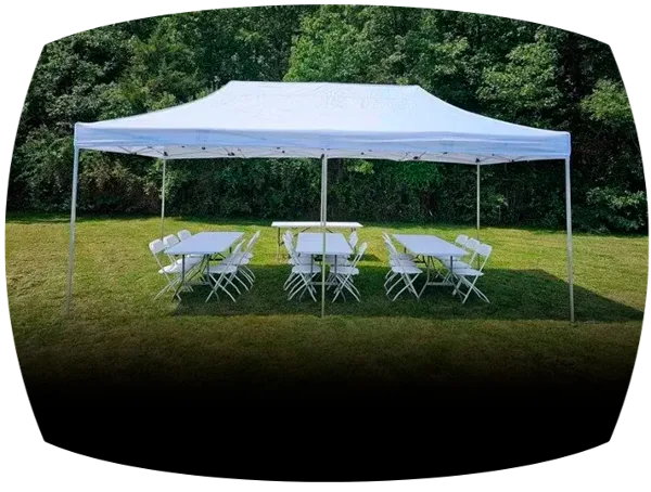 White canopy tent set up on a grassy lawn with rectangular tables and white folding chairs arranged underneath.