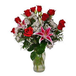 A floral arrangement featuring red roses and pink lilies in a clear glass vase.